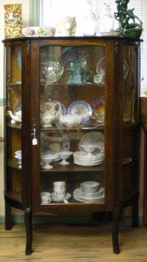 Curved front maple china cabinet, circa 1910, $500.